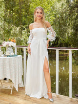 Off shoulder mermaid wedding dress with lace sleeves and side slit, elegantly displayed by a serene outdoor setting.