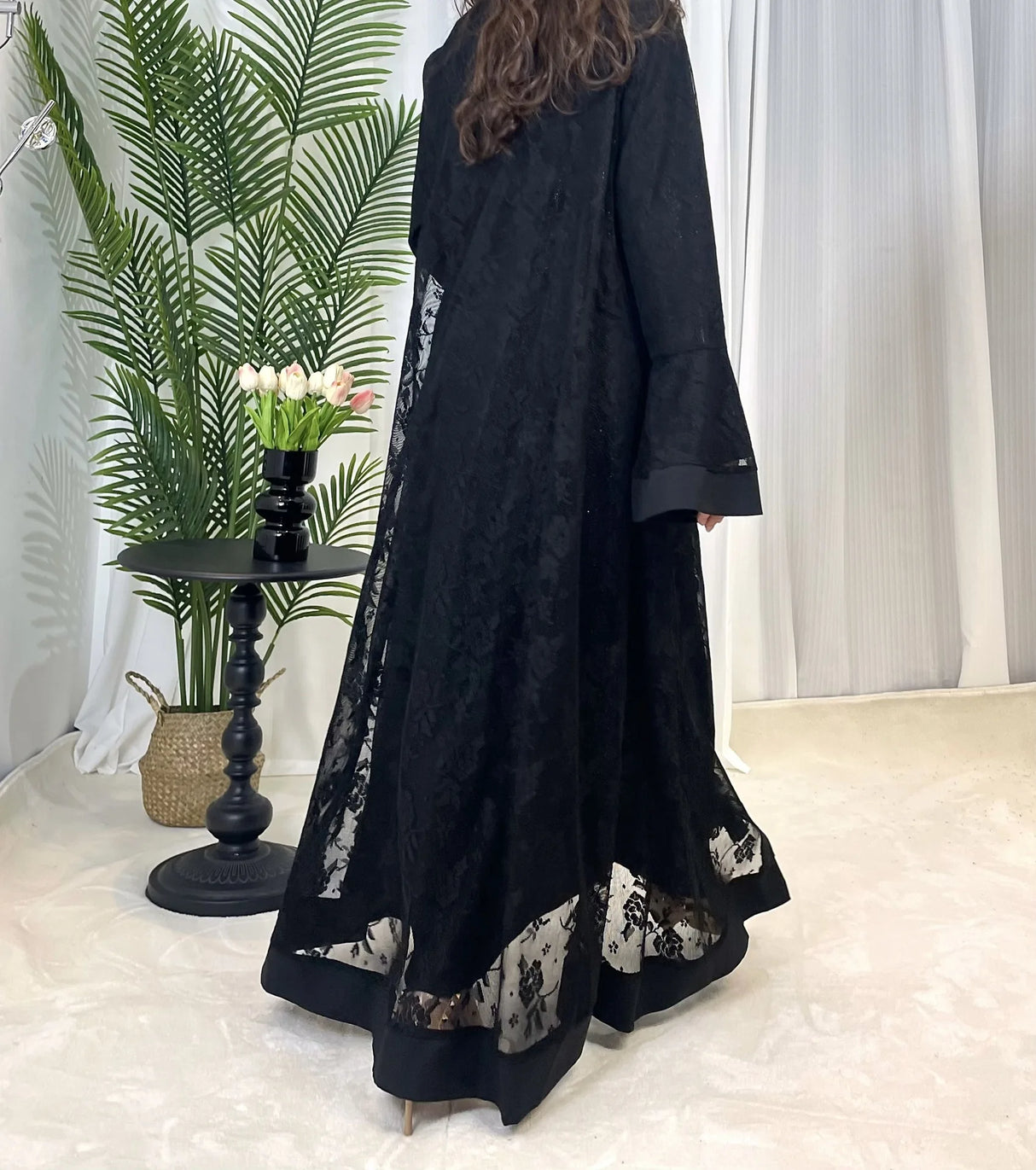Back view of a black Dubai Moroccan Kaftan for women, showcasing elegant lace details and a casual style.
