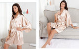 Elegant woman modeling a knee-length satin bridal robe in soft champagne color, showcasing its luxurious design and comfort.