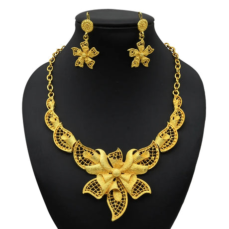Luxury Indian bridal jewelry set featuring a 24K gold plated necklace and matching flower earrings.