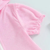 Close-up of toddler girls short sleeve pink hooded dress with ruched sleeve details.
