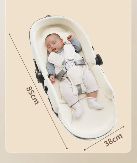Baby lying peacefully in a comfortable infant seat, measuring 85cm by 38cm, showcasing safety harness.