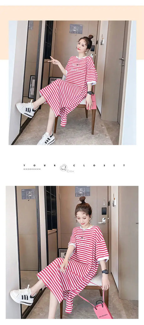 Woman wearing a striped maternity dress with a boat neck, sitting stylishly in a modern interior.