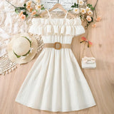 Girls summer casual dress with one-shoulder straps, ruffled neckline, and a belted waist in a light color.