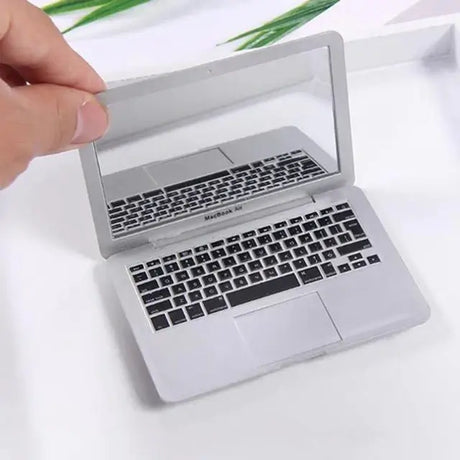 Miniature laptop mirror resembling a MacBook Air with detailed keyboard design, perfect for desk decor or gifts.