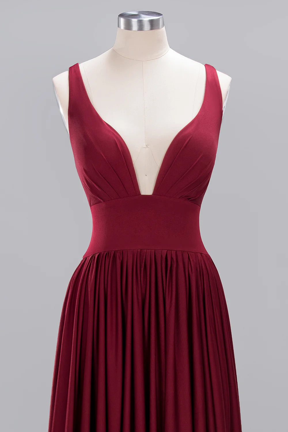 Burgundy V-neck bridesmaid evening dress featuring pleated floor-length skirt and sleeveless design.