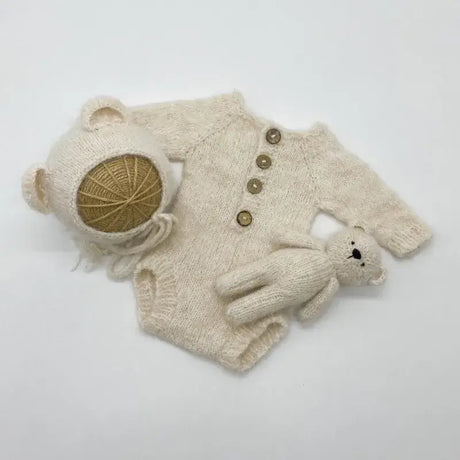 Newborn photo romper set with bear bonnet and toy, ideal for baby photography props.