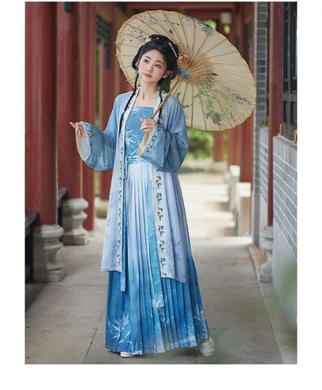 Women’s Hanfu cosplay in blue dress holding a parasol, showcasing traditional Chinese attire beauty and elegance.