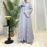 Model wearing a stylish Dubai Moroccan Kaftan in grey, showcasing elegant Islamic dress with floral design.