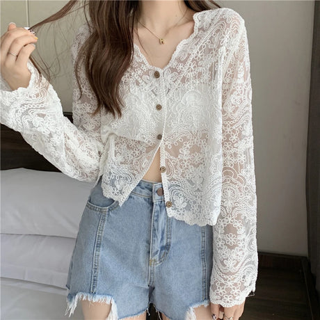 White sheer lace sun shirt with long sleeves and button closure, perfect for summer fashion.