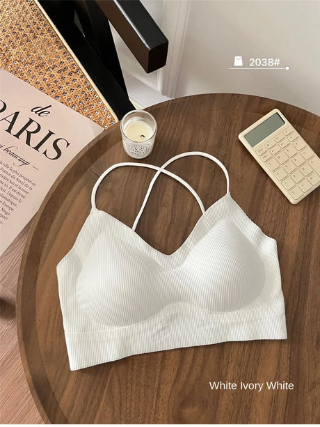 White ivory ribbed padded tank top with dual straps on a wooden table.