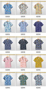 Colorful collection of printed short sleeve scrub tops displayed for healthcare professionals, featuring various designs and patterns.