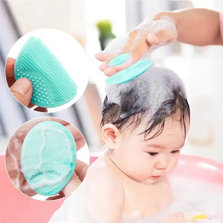 Baby silicone bath brush in use, gently shampooing a newborn's hair during bath time, safe and soft for sensitive skin.