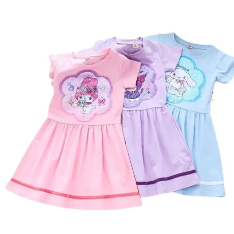 Girls summer dresses in pink, purple, and blue with cute cartoon graphics, perfect for ages 4-6. Fashionable and knee-length.
