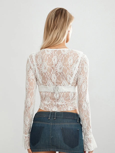 Back view of TieGlam™ sheer lace crop cardigan with flare sleeves, styled with a denim skirt.