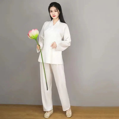 Woman wearing elegant white Hanfu costume holding a lotus flower, showcasing traditional Tang Dynasty attire.