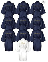 Collection of satin bride and bridesmaid robes in navy and white with gold lettering, perfect for wedding celebrations.