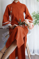 Model wearing an orange Cotton Jacquard Cheongsam Qipao dress with floral decor and elegant lace details.