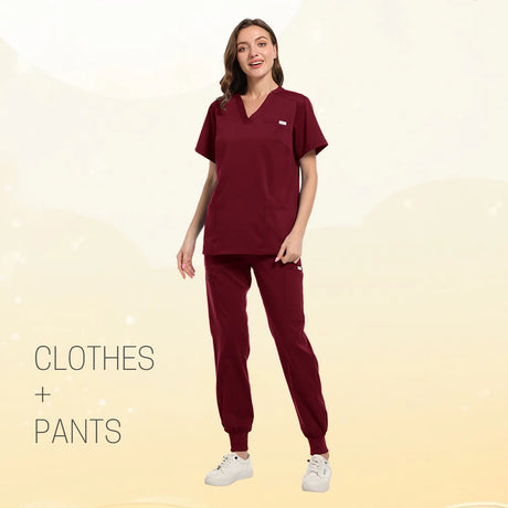 Model wearing burgundy multicolor scrub set featuring short sleeves and jogger pants.