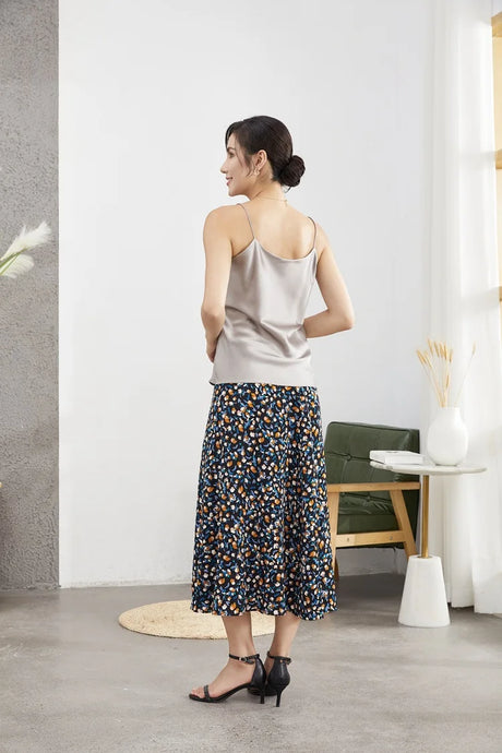 Back view of a woman wearing a double-layer silk camisole with a floral skirt, showcasing summer casual style.