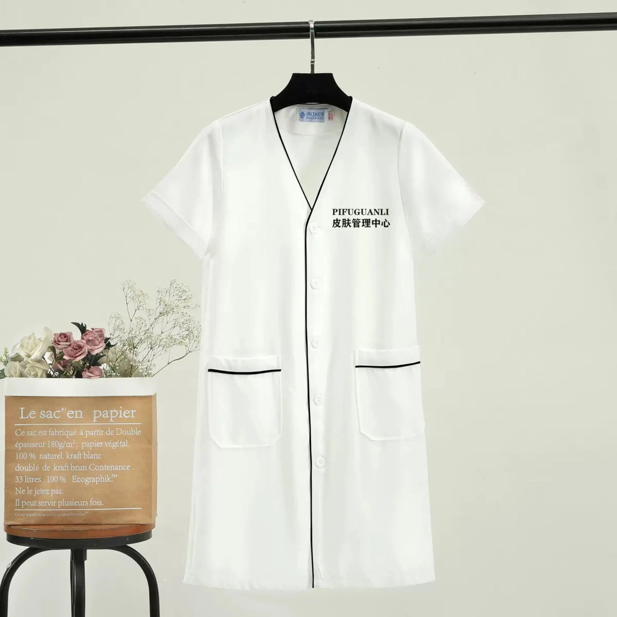 Custom white beauty uniform lab coat with pockets and v-neck for women, ideal for salons and medical settings.