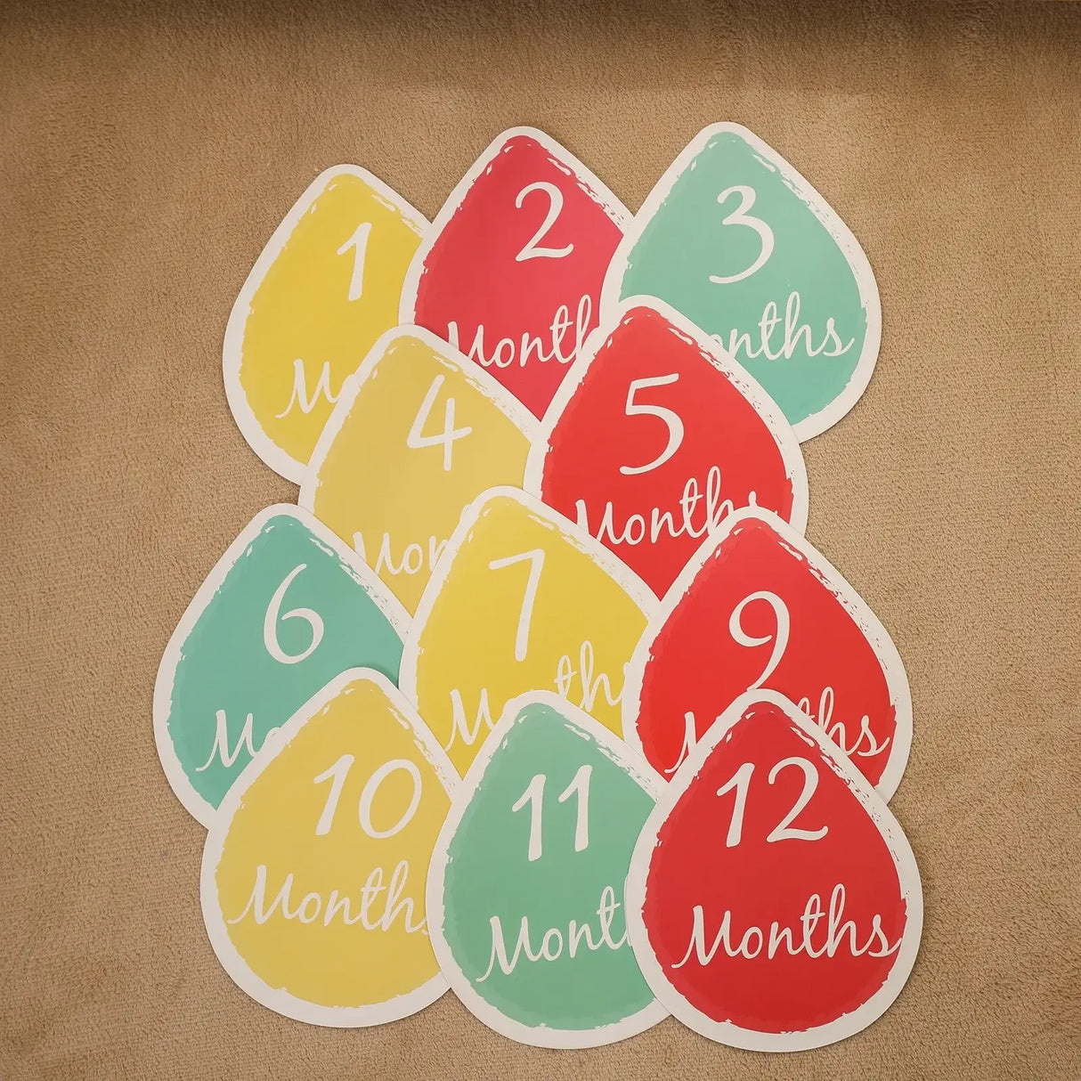 Colorful baby milestone cards for monthly photography, featuring 1 to 12 months in teardrop shapes.