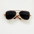 Stylish black sunglasses with gold frames, perfect for trendy photo shoots or accessories for babies.