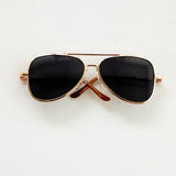 Stylish black sunglasses with gold frames, perfect for trendy photo shoots or accessories for babies.