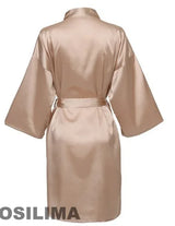 Back view of a silk satin kimono-style robe in beige, featuring wide sleeves and a belt.