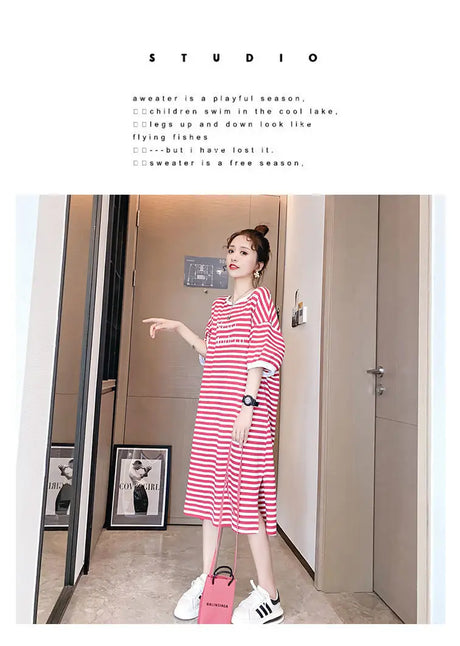 Striped maternity dress showcased in a studio setting, featuring a loose fit and playful style.