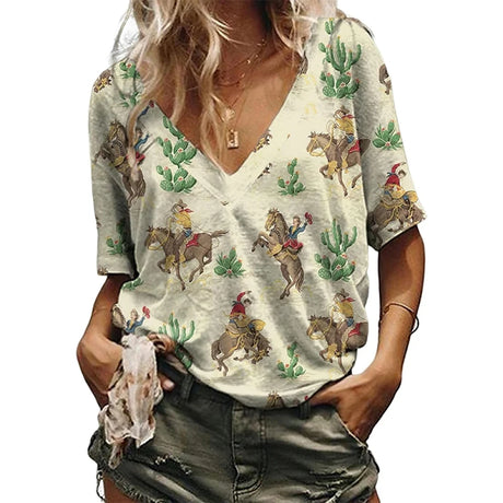 Women wearing a V-neck Western Cowgirl graphic t-shirt featuring cowboy and cactus illustrations.