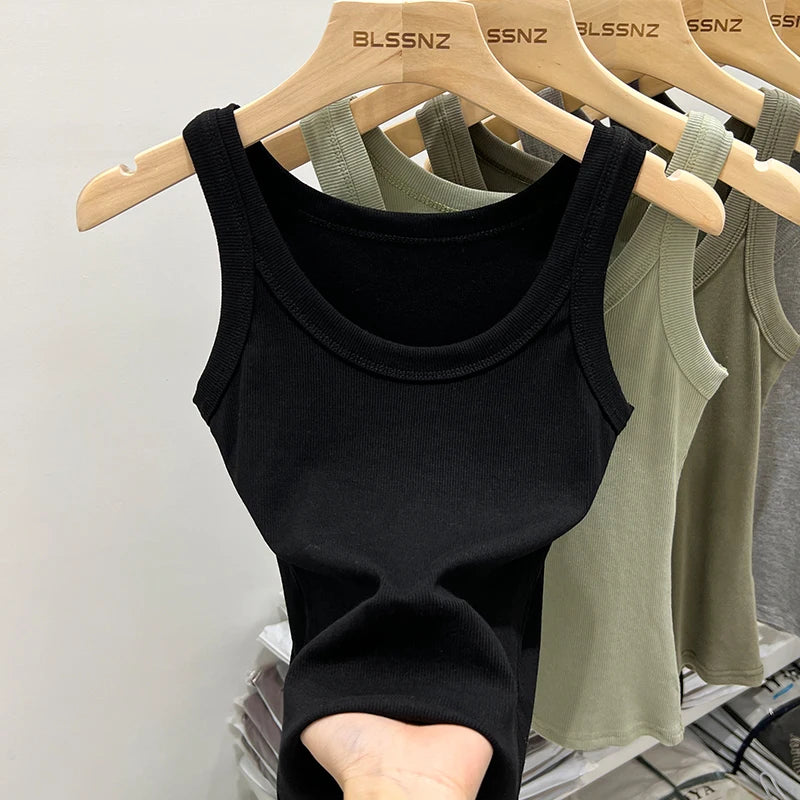 Black RibFlex™ Basic O-Neck Tank top displayed among various colors on hangers, highlighting summer comfort and style.