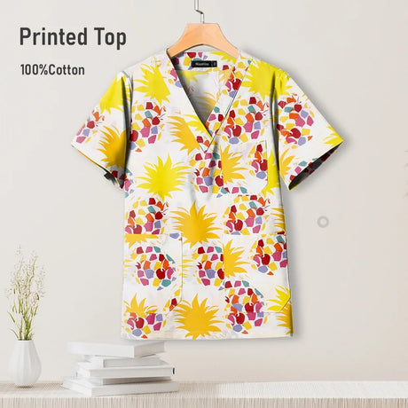Colorful pediatric surgical scrub top in cotton with a floral print, perfect for medical professionals and nursing uniforms.