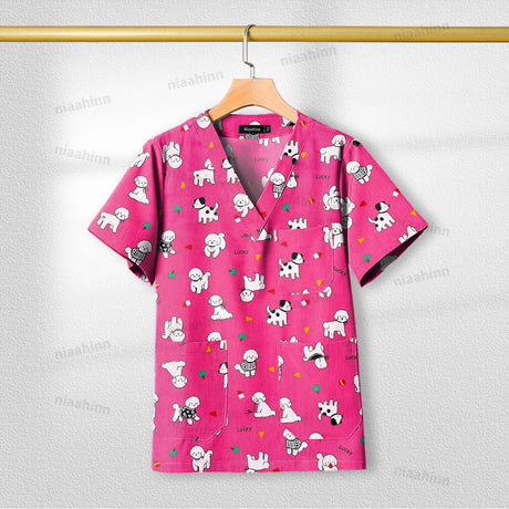 Printed pink nursing scrub top with dog patterns, short sleeve, designed for women in healthcare settings.