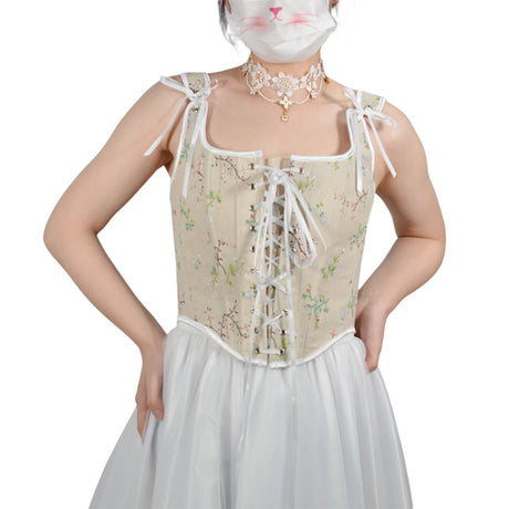 Woman wearing a floral retro corset cropped camisole top with a white skirt, ideal for summer parties.