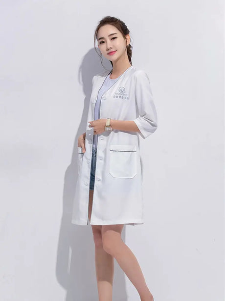 Model wearing a custom white short sleeve lab coat designed for beauty and spa professionals.
