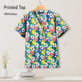 Colorful pediatric nursing scrub top with floral print, 100% cotton, breathable fabric for comfort.