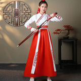 Traditional Chinese Hanfu dress in vibrant red, worn by a model holding a sword, showcasing streetwear style.