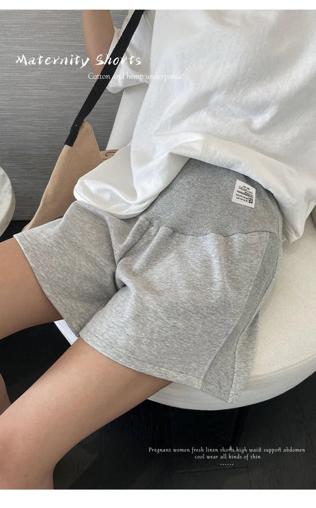 Plus size adjustable maternity shorts in comfortable grey fabric, perfect for summer wear and designed for loose fit.