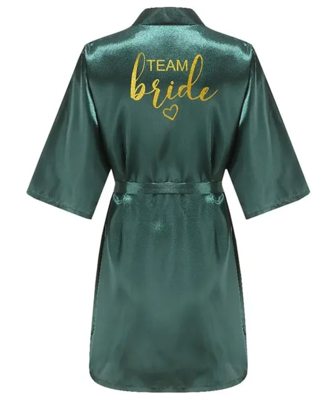 Green satin kimono robe with gold 'TEAM BRIDE' text on the back, perfect for bridal parties.