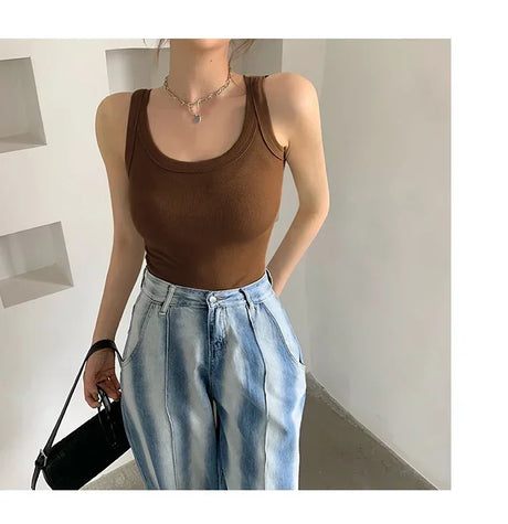 RetroRib™ sleeveless vintage ribbed tank top in brown, paired with light blue baggy jeans for a stylish streetwear look.