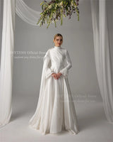 Elegant Muslim satin wedding dress featuring pearls, high neck, and long sleeves, perfect for any age.