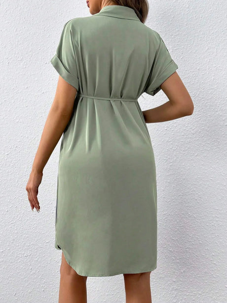 Back view of a casual green maternity button shirt dress, featuring a turn-down collar and rolled sleeves.