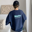Back view of an oversized navy streetwear tee with 'Newtro' graphic. Perfect for casual and trendy outfits.