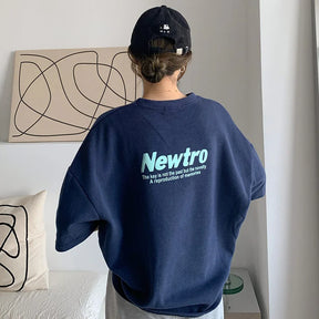 Back view of an oversized navy streetwear tee with 'Newtro' graphic. Perfect for casual and trendy outfits.
