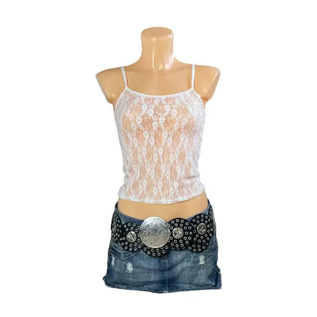 LaceMuse™ vintage spaghetti strap top, sheer lace design styled with denim skirt and decorative belt.