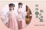 Girls in a pink Chinese Hanfu cosplay dress, showcasing delicate embroidery and flowing sleeves for a fairy-like appearance.