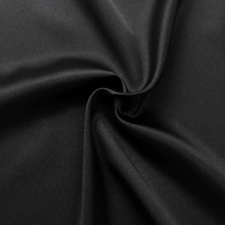 Close-up of luxurious black fabric, showcasing its smooth texture and sheen, perfect for elegant clothing.