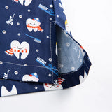 Close-up of colorful tooth-themed fabric on women's nurse scrubs, ideal for medical and beauty professionals.
