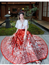 Woman in Traditional Hanfu oversized embroidered blouse paired with a vibrant floral skirt, showcasing elegant Chinese fashion.